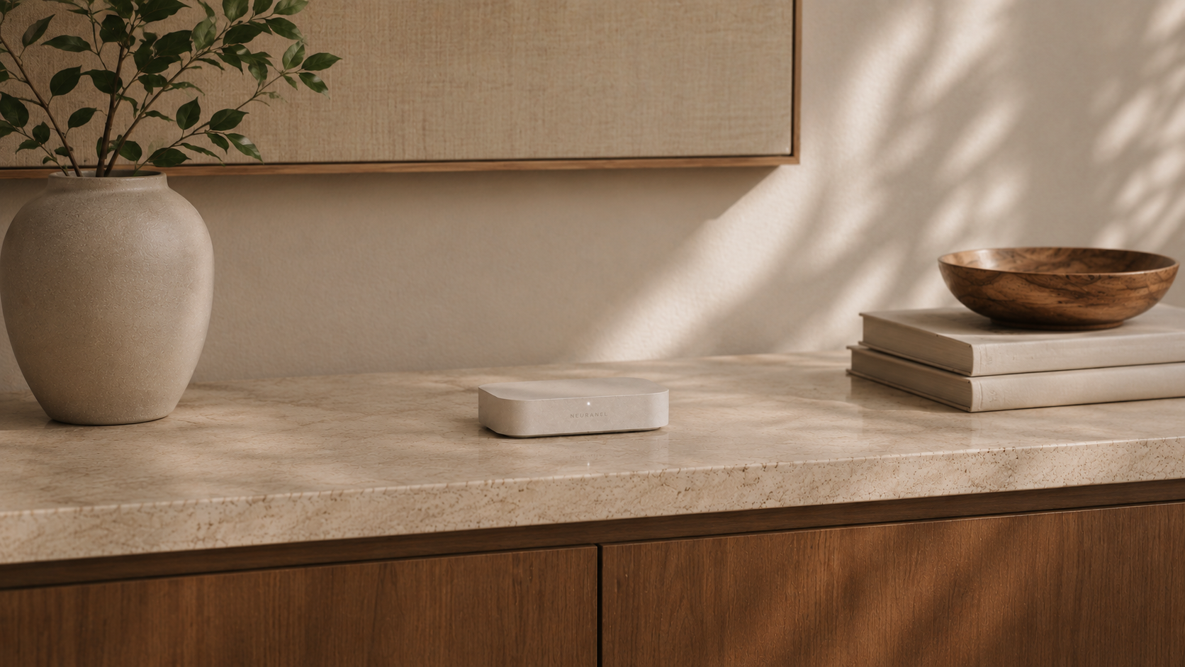 NeuraLink on a stone console in a warm interior